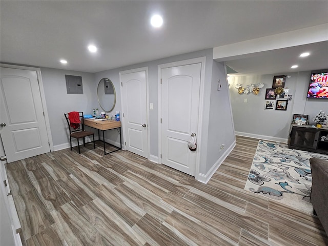 interior space with electric panel and light hardwood / wood-style floors