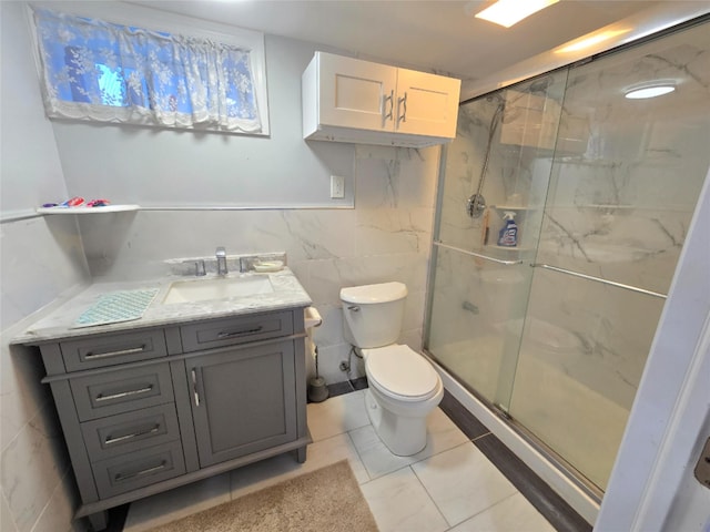 bathroom with walk in shower, vanity, tile patterned flooring, and tile walls