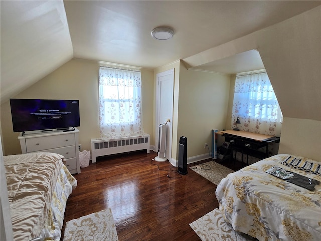 bedroom with lofted ceiling, radiator heating unit, and dark hardwood / wood-style floors