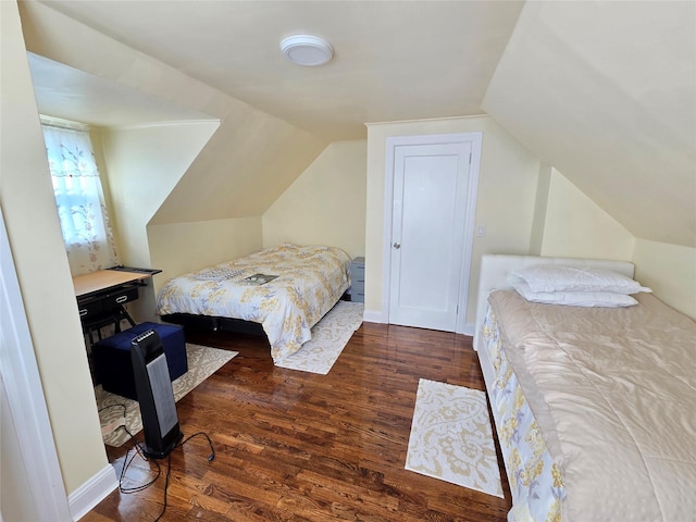 bedroom featuring vaulted ceiling and dark hardwood / wood-style floors