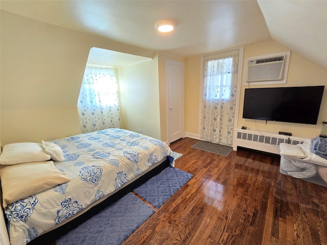 bedroom with lofted ceiling, an AC wall unit, and dark wood-type flooring