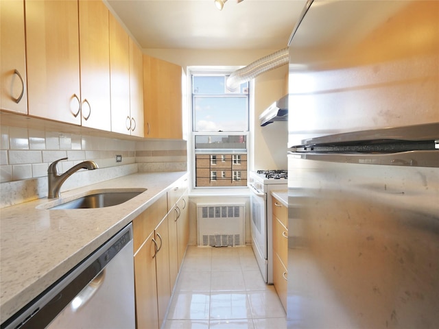 kitchen with exhaust hood, sink, light tile patterned floors, appliances with stainless steel finishes, and tasteful backsplash