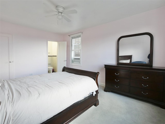 bedroom with ensuite bath, ceiling fan, and light colored carpet