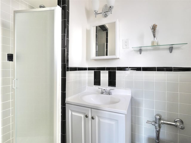 bathroom featuring vanity and tile walls