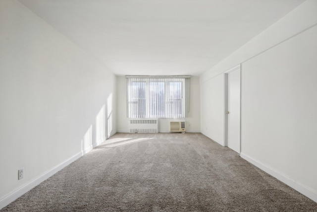 carpeted spare room with radiator heating unit