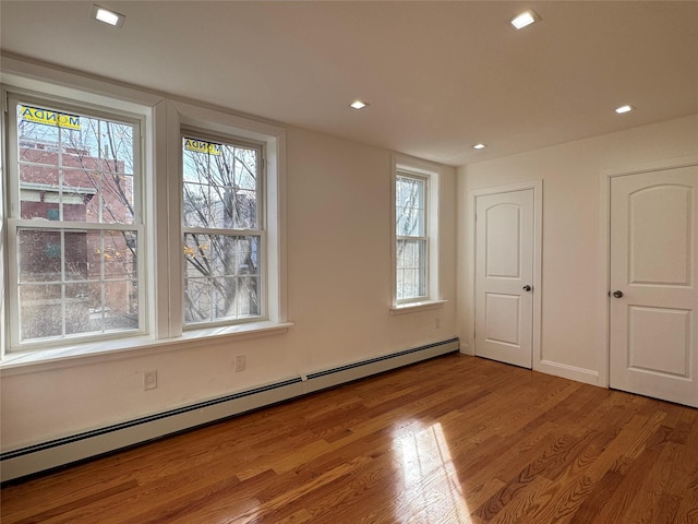 interior space featuring light hardwood / wood-style floors and baseboard heating