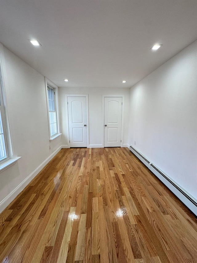 interior space featuring light wood-type flooring and baseboard heating