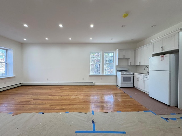 kitchen featuring tasteful backsplash, white cabinets, white appliances, and hardwood / wood-style flooring