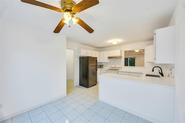 kitchen featuring white cabinets, black fridge, sink, decorative backsplash, and white range with electric stovetop