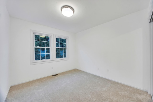 empty room featuring light carpet