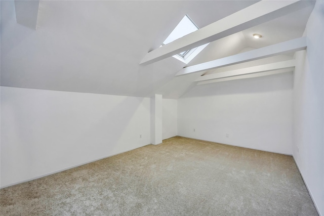 bonus room featuring lofted ceiling with skylight and light carpet