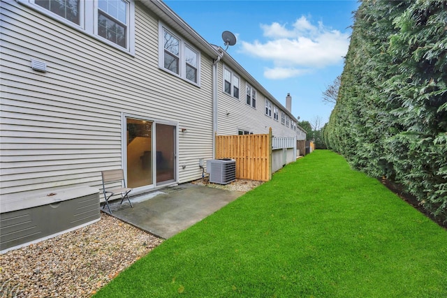 view of yard featuring cooling unit and a patio