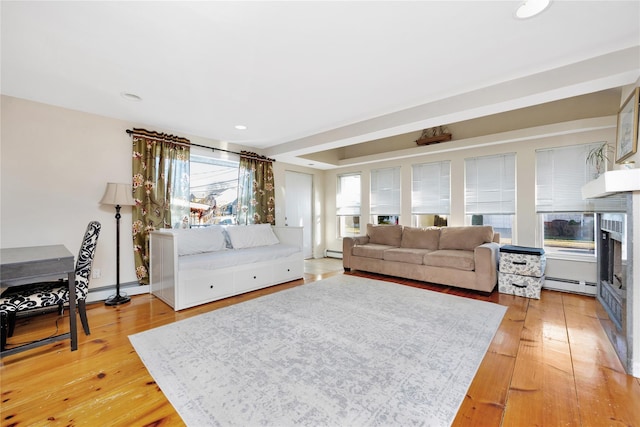 living room featuring hardwood / wood-style floors and a baseboard heating unit