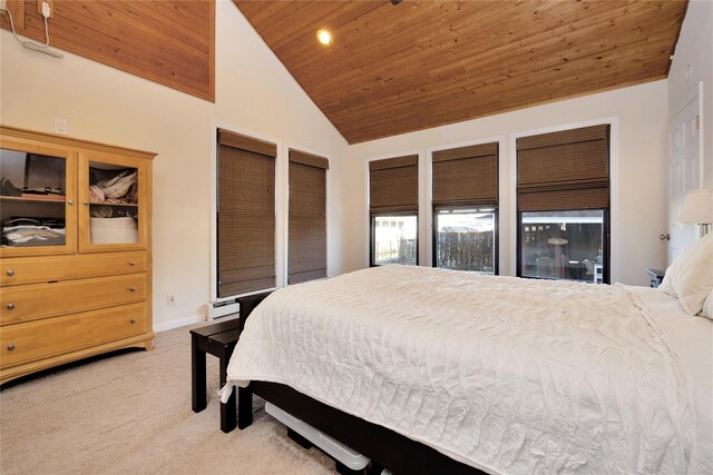 carpeted bedroom with wood ceiling, baseboard heating, and high vaulted ceiling