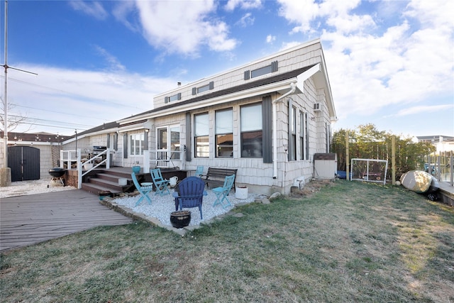 back of house with a lawn and a wooden deck