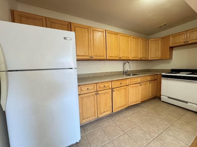 kitchen featuring sink, light tile patterned flooring, and white appliances