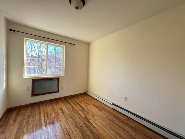 spare room featuring light hardwood / wood-style floors and baseboard heating