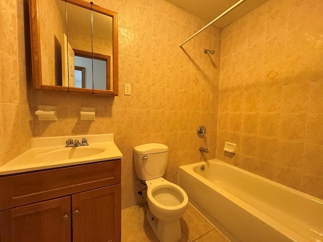 full bathroom featuring tiled shower / bath combo, tile patterned floors, toilet, vanity, and tile walls