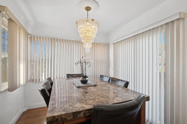 dining room with hardwood / wood-style floors and an inviting chandelier