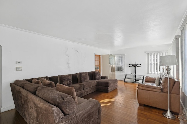 living room with crown molding and hardwood / wood-style floors