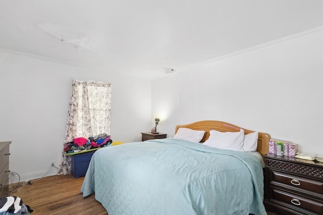 bedroom featuring crown molding and hardwood / wood-style flooring