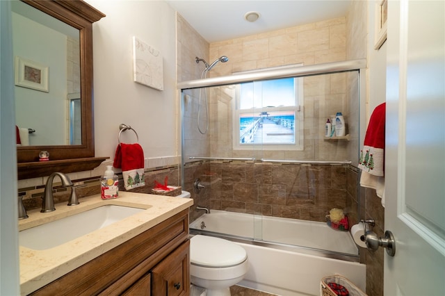 full bathroom with shower / bath combination with glass door, vanity, and toilet