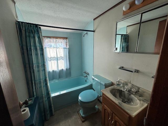 full bathroom with vanity, shower / tub combo, a textured ceiling, and toilet