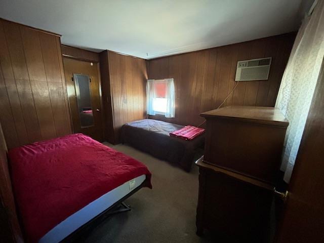 carpeted bedroom featuring wood walls and a wall mounted AC