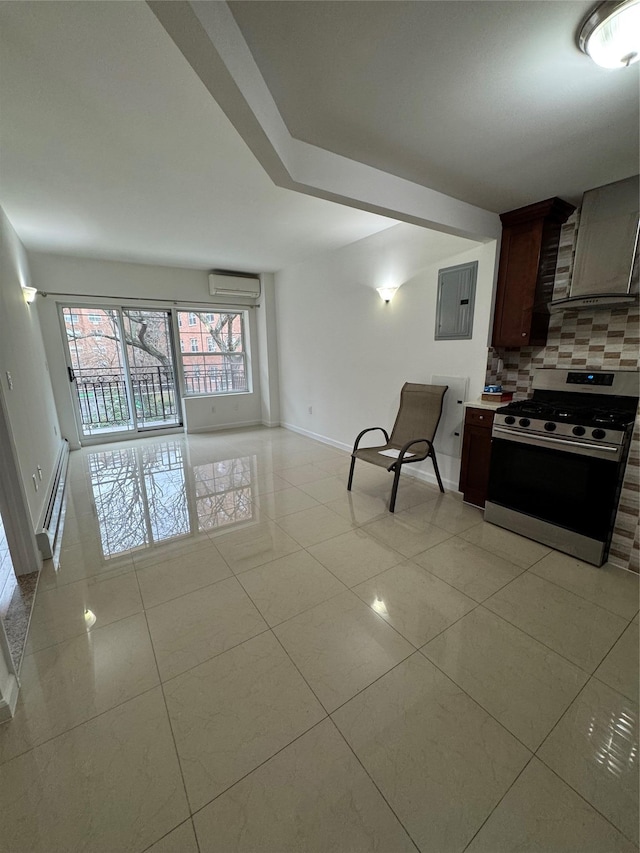 kitchen featuring tasteful backsplash, a wall mounted AC, light tile patterned floors, and stainless steel range oven