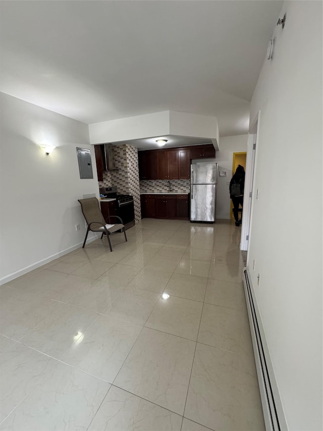 kitchen featuring stainless steel appliances, baseboard heating, tasteful backsplash, and sink