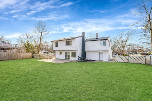 rear view of property featuring central AC unit, a patio area, and a lawn