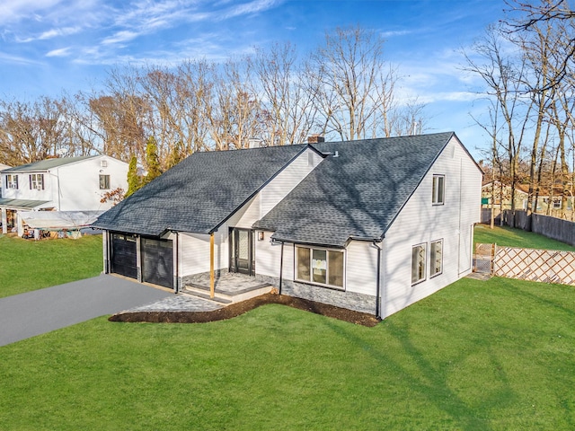 view of front of property featuring a garage and a front lawn