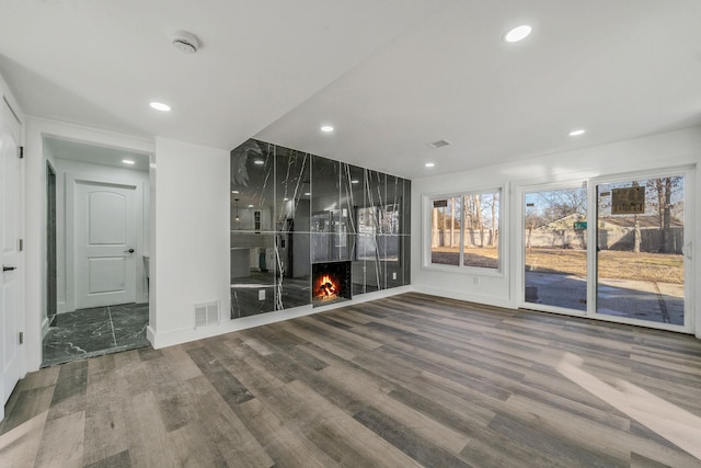 interior space with hardwood / wood-style flooring and a fireplace