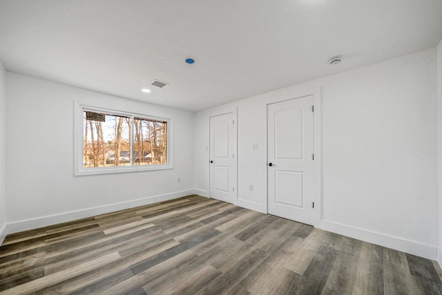 unfurnished bedroom with dark hardwood / wood-style floors