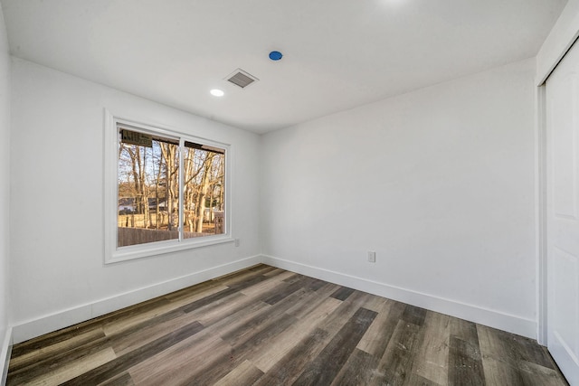 empty room featuring dark hardwood / wood-style flooring