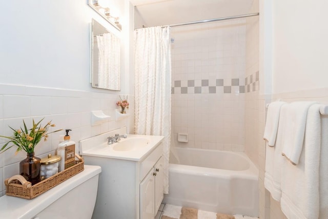 full bathroom with vanity, shower / bath combination with curtain, tile walls, and toilet