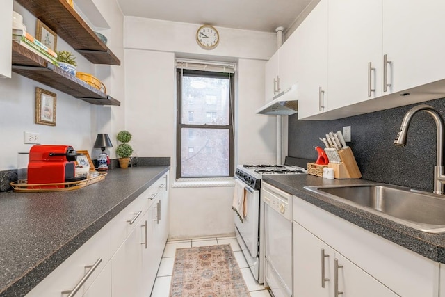 kitchen featuring sink, light tile patterned floors, white appliances, decorative backsplash, and white cabinets