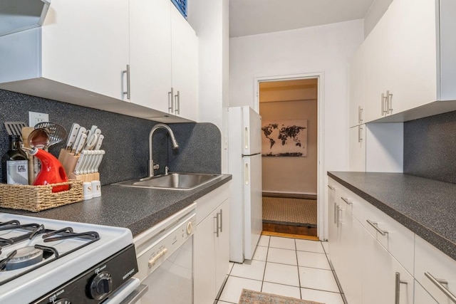 kitchen featuring decorative backsplash, white appliances, sink, light tile patterned floors, and white cabinets