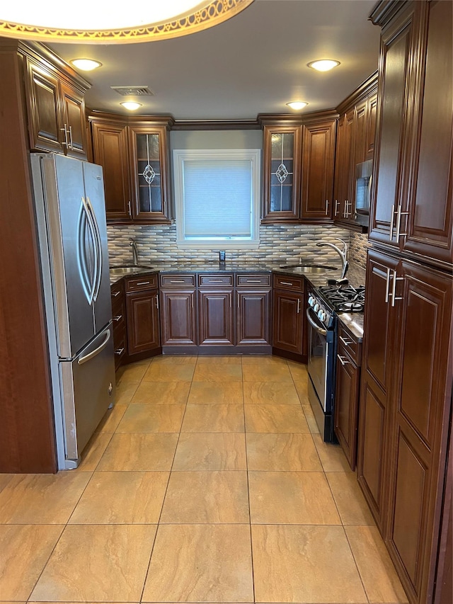 kitchen with sink, stainless steel appliances, decorative backsplash, light tile patterned floors, and ornamental molding