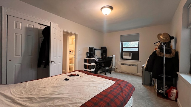 bedroom with light carpet, ensuite bathroom, a closet, and cooling unit