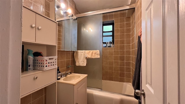 bathroom featuring vanity and enclosed tub / shower combo