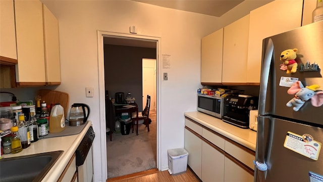 kitchen with appliances with stainless steel finishes and light hardwood / wood-style flooring