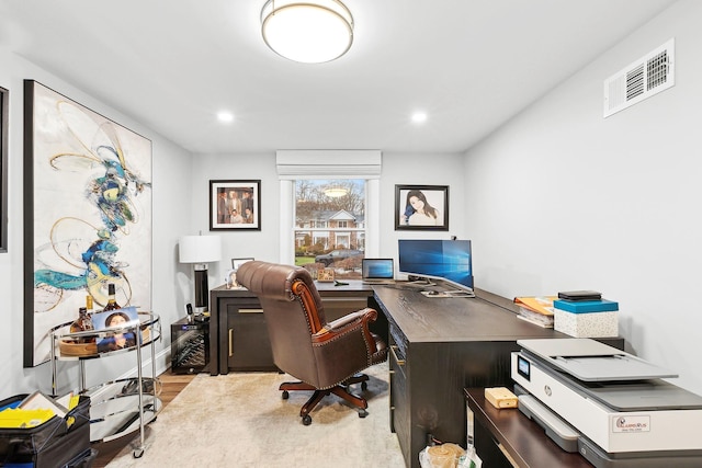 home office with light hardwood / wood-style flooring