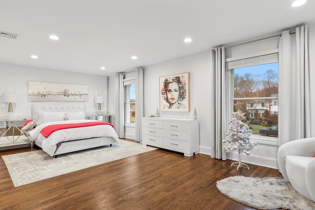 bedroom featuring dark hardwood / wood-style flooring and multiple windows