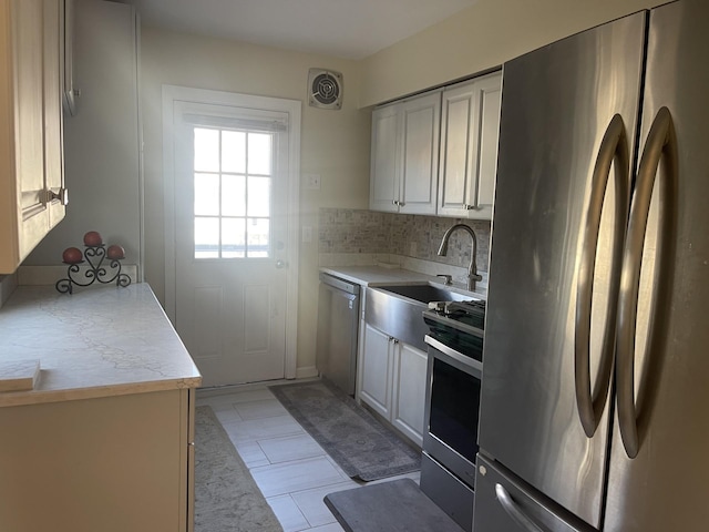 kitchen featuring backsplash, stainless steel appliances, and sink