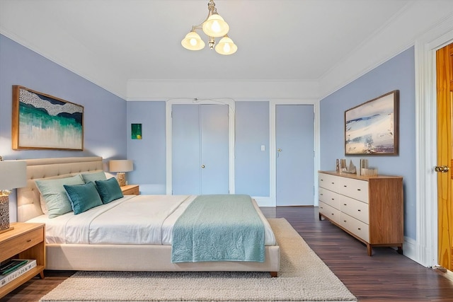 bedroom featuring dark hardwood / wood-style flooring and crown molding