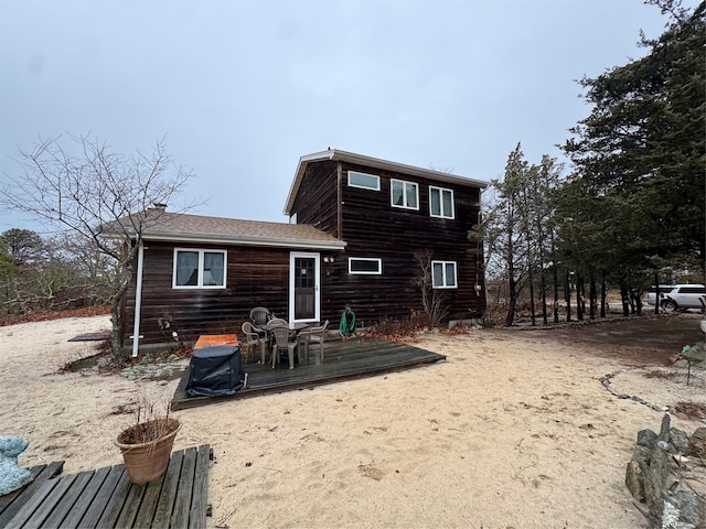 rear view of property featuring a deck