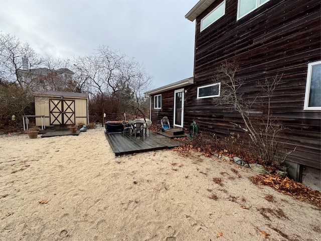 view of yard with a shed and a wooden deck