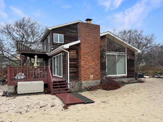 65 Lake Dr, Southold, NY 11971 - view of side of home with a balcony, a chimney, and a wooden deck