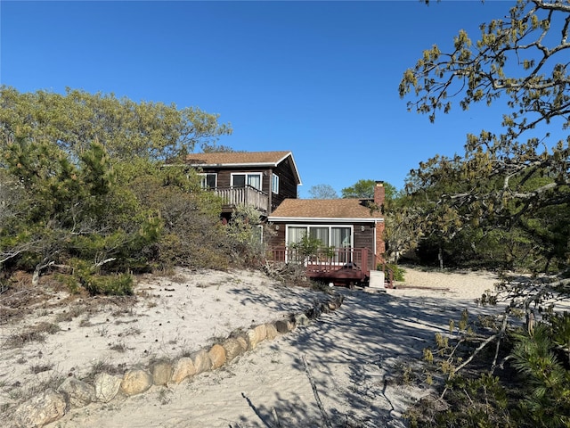 65 Lake Dr, Southold, NY 11971 - view of side of property with a chimney and a deck